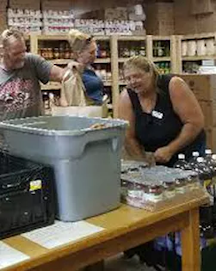 three people stocking items at a food pantry