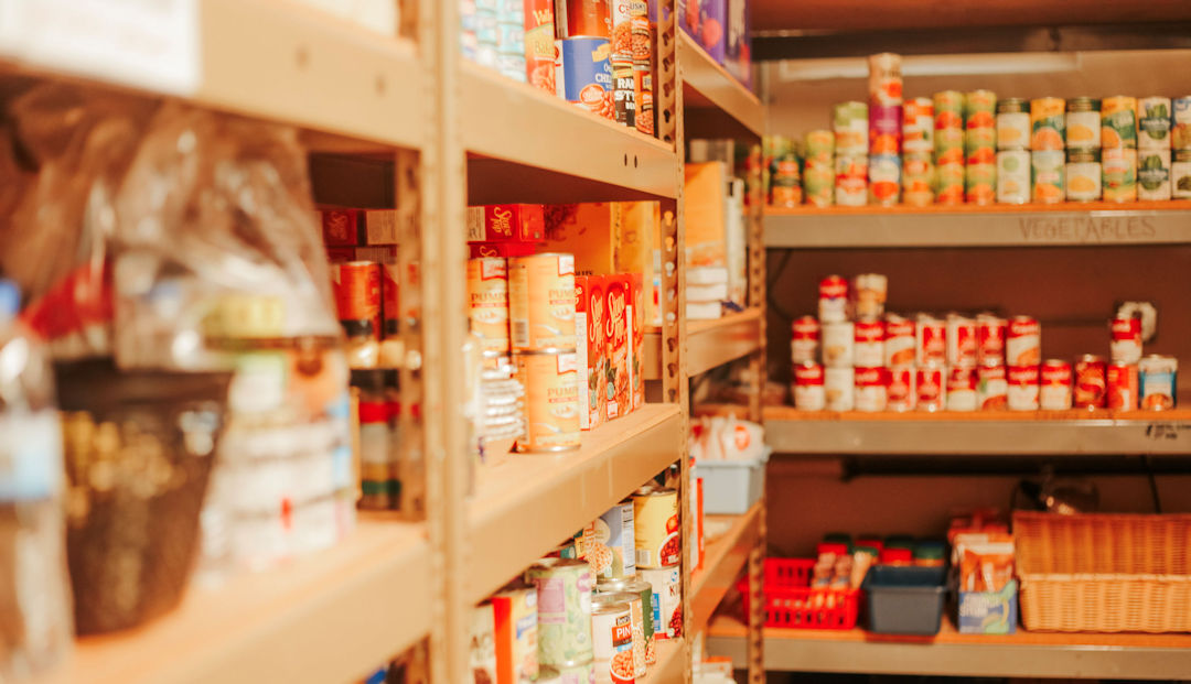 shelves filled with canned food and hygiene products at a food pantry